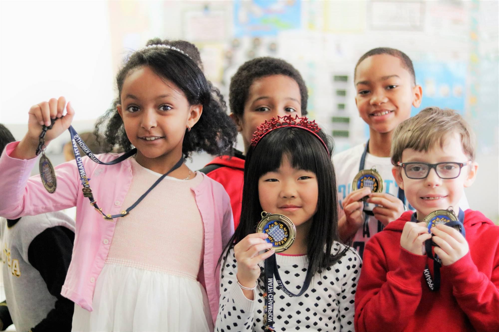 Group of students holding medals